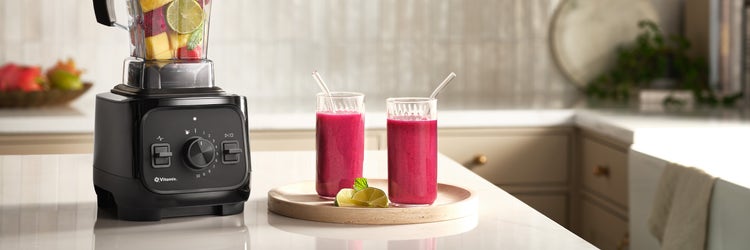 VX1 blender with two fresh fruit smoothie cups on countertop