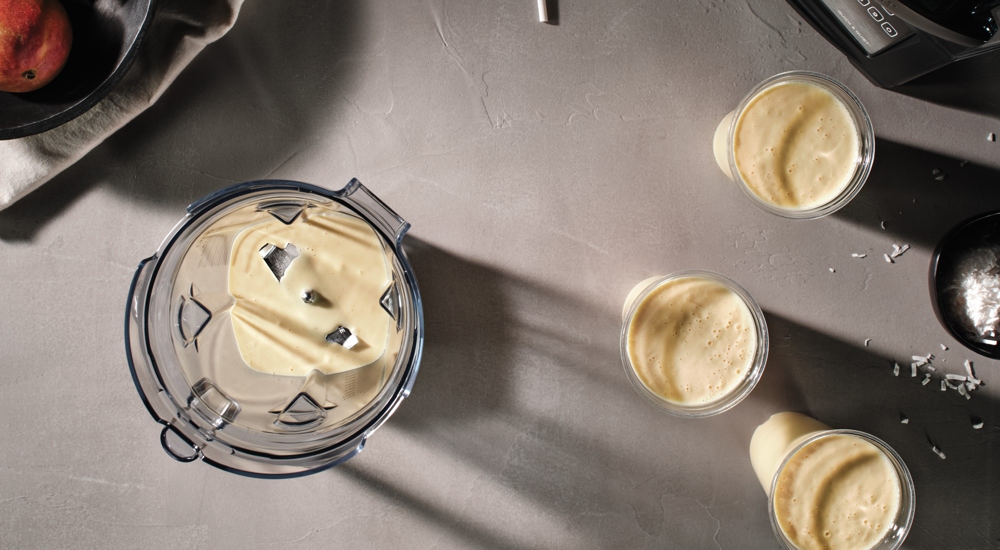 blender with smoothie and cups