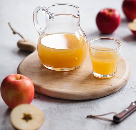 Apple Juice Apple juice in a pitcher on a wooden platter with a glass