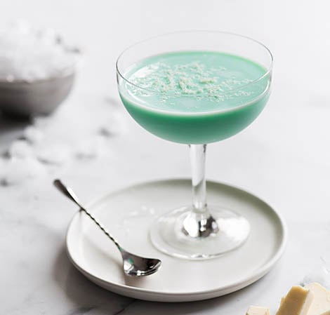 Grasshopper Bright green drink in a martini glass with white chocolate shavings on top