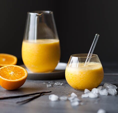 Orange Juice Plus Homemade orange juice in a glass pitcher and glass