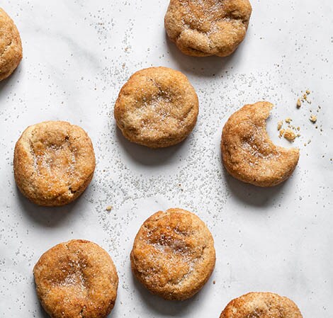 Snickerdoodles snickerdoodles on a counter with a bite taken out of one cookie