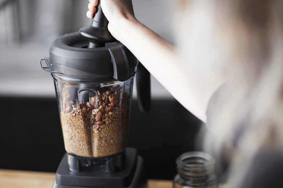 processing almond butter in a blender container
