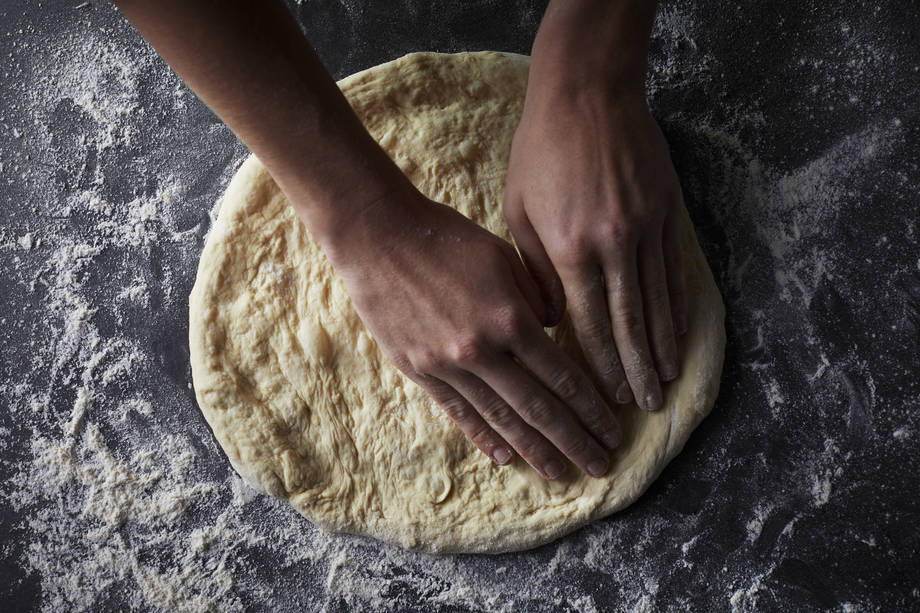 forming pizza dough into round shape